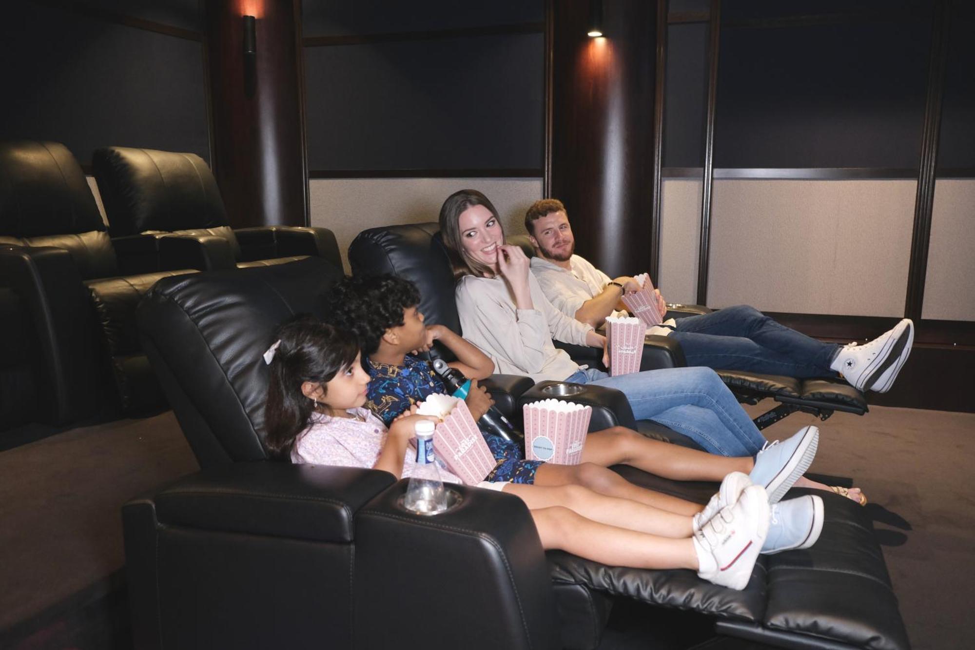 Charthouse Bahrain Hotel Al-Manamah Bagian luar foto A family watching a movie in a home theater