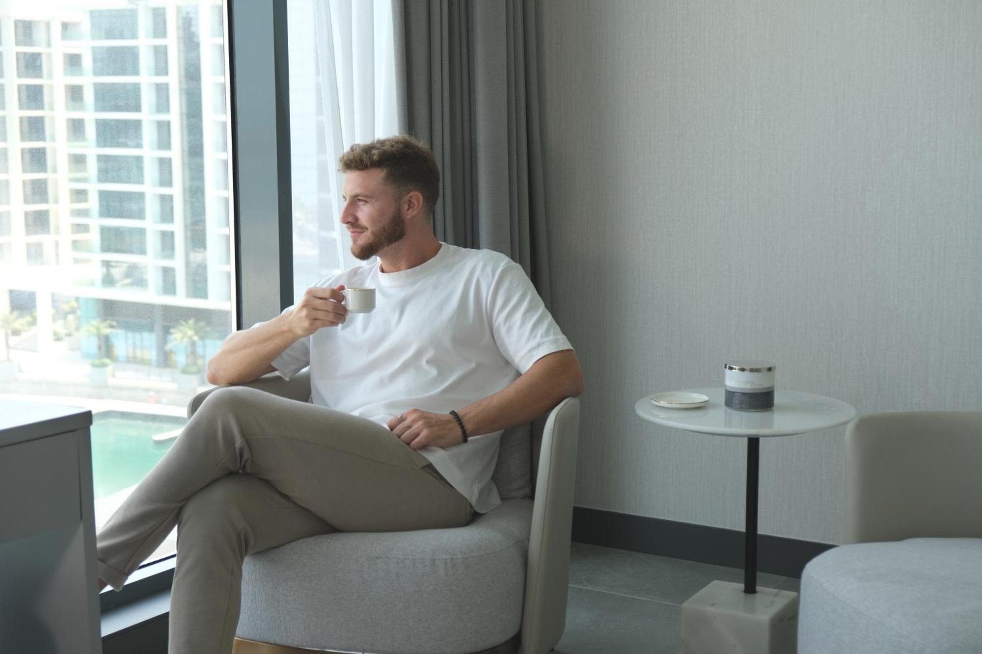 Charthouse Bahrain Hotel Al-Manamah Bagian luar foto A man drinking coffee